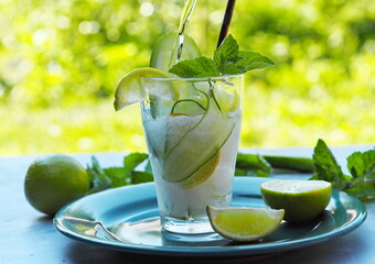 A natural drink with ice, cucumber, lemon and lime to cool in the heat. Summer drink.