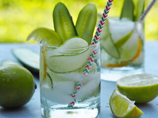 A natural drink with ice, cucumber, lemon and lime to cool in the heat. Summer drink.