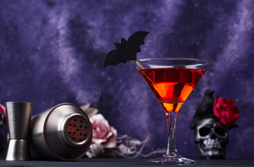 Halloween martini cocktail on purple background