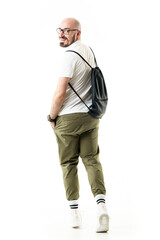 Back view of funny happy hipster style geek walking and turning to camera. Full length portrait isolated on white background