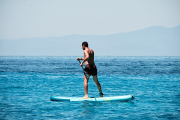 man practicing paddle in the ocean