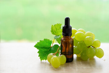Bottles with grape oil on table