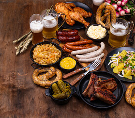 Oktoberfest dishes with beer, pretzel and sausage