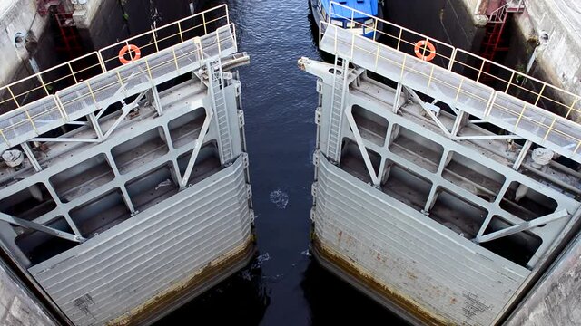 The opening gates of the sluice to the hydroelectric power station and the seething water fills the sluice for the passage of the ship.
