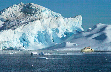 icebergs in the sea and a boat under the sky and the clouds, Ilulissat Icefjord, Illulissat, Greenland