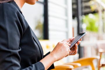 Close-up of a business woman using a modern smartphone. female hand typing message on mobile phone social network concept.