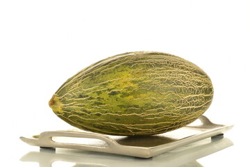One juicy organic melon on a metal tray, close-up, isolated on white.