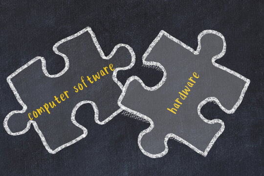 Chalk drawing of two puzzles with words computer software and hardware