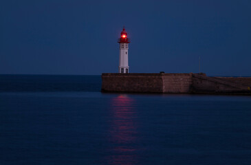 A Lighthouse with red light at night, Almeria, Spain