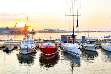 Private sailing yachts are moored in the sea at the pier.