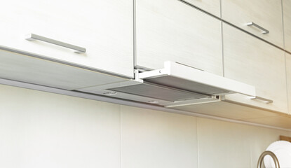 Power on cooker hood in modern kitchen interior, kitchen applicance concept background photo