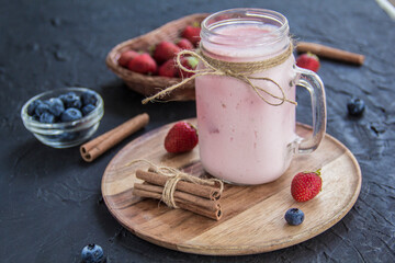 Healthy smoothie of fresh summer berries. Creative atmospheric decoration