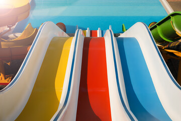 Colorful slides in water park on sunny day
