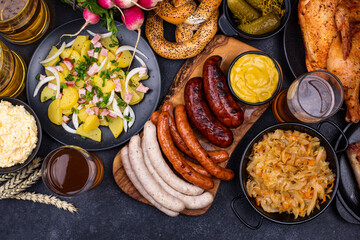 Oktoberfest dishes with beer, pretzel and sausage