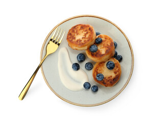 Delicious cottage cheese pancakes served with fresh blueberries and sour cream on white background, top view
