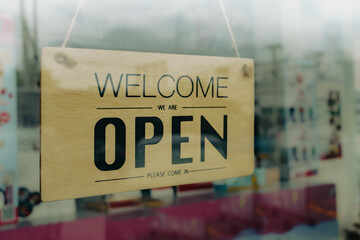 shop opening sign on glass door,