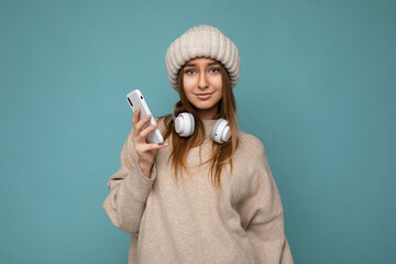 Photo of beautiful sexy young dark blonde woman wearing beige stylish sweater and knitted beige...