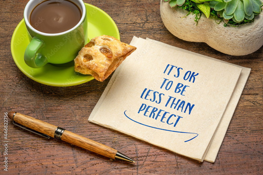 Wall mural it is OK not to be less than perfect - inspirational handwriting on a napkin with a cup of coffee, acceptance, positive mindset, success and personal development concept