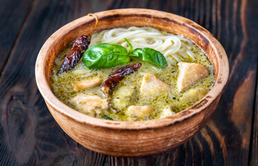 Bowl of green curry with noodles