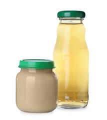 Baby food in jar near bottle of juice on white background