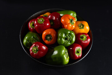 Colorful bell pepper on black plate