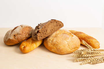 baked bread,  fresh bread with wheat ears, bread on a wooden table