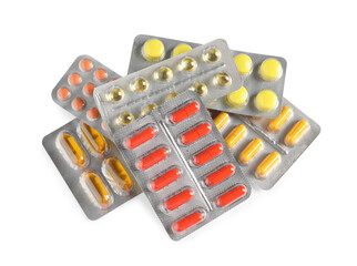 Blisters with different pills on white background, top view