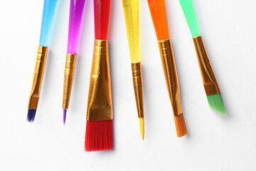 Fototapeta premium Set of different paintbrushes on white background, top view