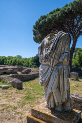 Rome, Ostia Antica, Italy. Ancient Roman ruins, detail of a Roman statue in marble togata Ostia Antica archaeological park. Roman port along the Tiber and the Tyrrhenian Sea. 