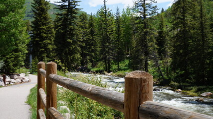 The river in the forest with a fence near Vail, CO