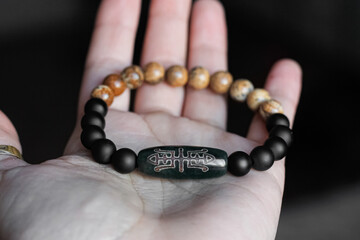 on the human palm is a bracelet made of natural precious stones