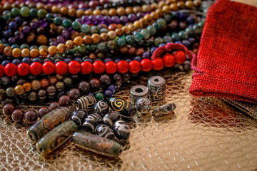a variety of beads made of natural stones, Tibetan ji beads and metal inserts are randomly...