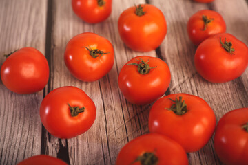 Indian Fresh Tomatoes in bamboo basket on wooden table	
