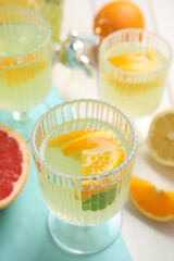 Obraz na płótnie Canvas Delicious refreshing lemonade with orange slices on white table
