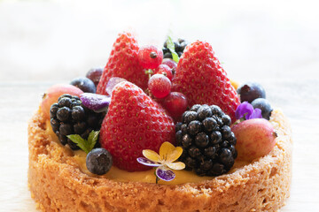 Tartlets (tarts, open pastry pies) fresh berries (straberry, raspberry and blueberry) 
