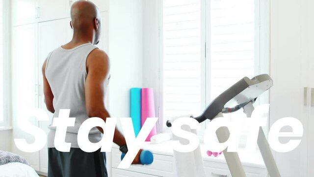 Animation os stay safe text over man lifting weights exercising at home