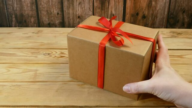 Gift parcel box with ribbon red bow, brown carton parcel, surprise