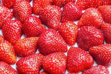 Full frame of fresh and juicy strawberry halves