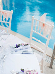 Amazing wedding decor in front of swimming pool. Ceremony concept. Beautiful flower.