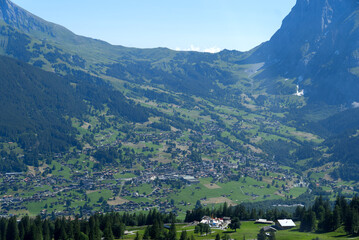 Fototapeta na wymiar Aerial view of village Grindelwald at bernese Oberland on a sunny summer day. Photo taken July 20th, 2021, Lauterbrunnen, Switzerland.