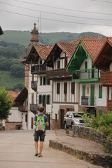 Fototapeta na wymiar Typical Basque houses with a boy walking down the street in Arizcun, Navarra