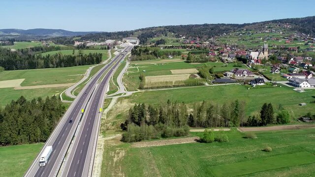 New highway in Poland on national road no 7, E77, called Zakopianka.  Skomielna  Biała village on the right. Aerial 4K panning video