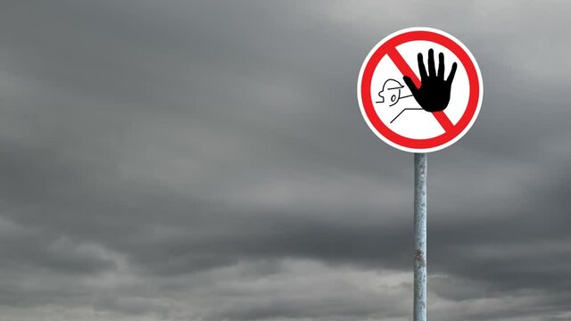 Stop signboard post with against dark clouds in the blue sky
