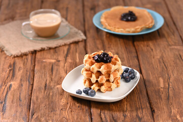 Appetizing waffles with jam for dessert.