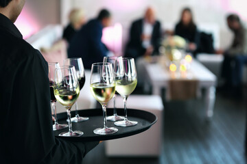 Waitress distributes wine for the wedding guests or event.
