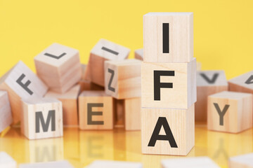 acronym IFA from wooden blocks with letters, concept