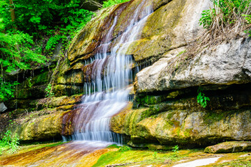 Beautiful waterfall on small river in a park