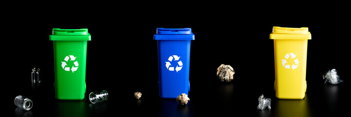 Recycling set bins. Yellow, green, blue dustbin for recycle plastic, paper and glass can trash isolated on black background. Container for disposal garbage waste and save environment.