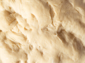 Process of raising the dough in a special basket. Dough made from natural sourdough. Wheat dough. Fermentation. Top view.	