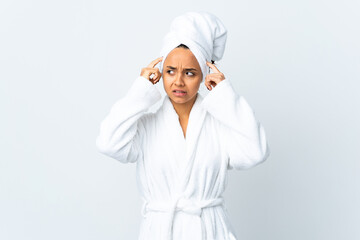 Young woman in bathrobe over isolated white background having doubts and thinking